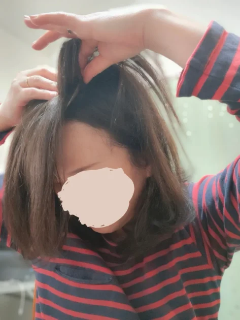 ヘアピースサイドのクリップを留めている様子